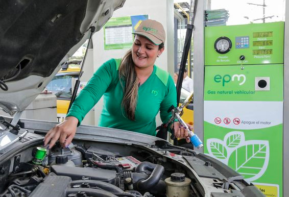 Imagen con trabajador agregando gas natural vehicular en estación de servicio